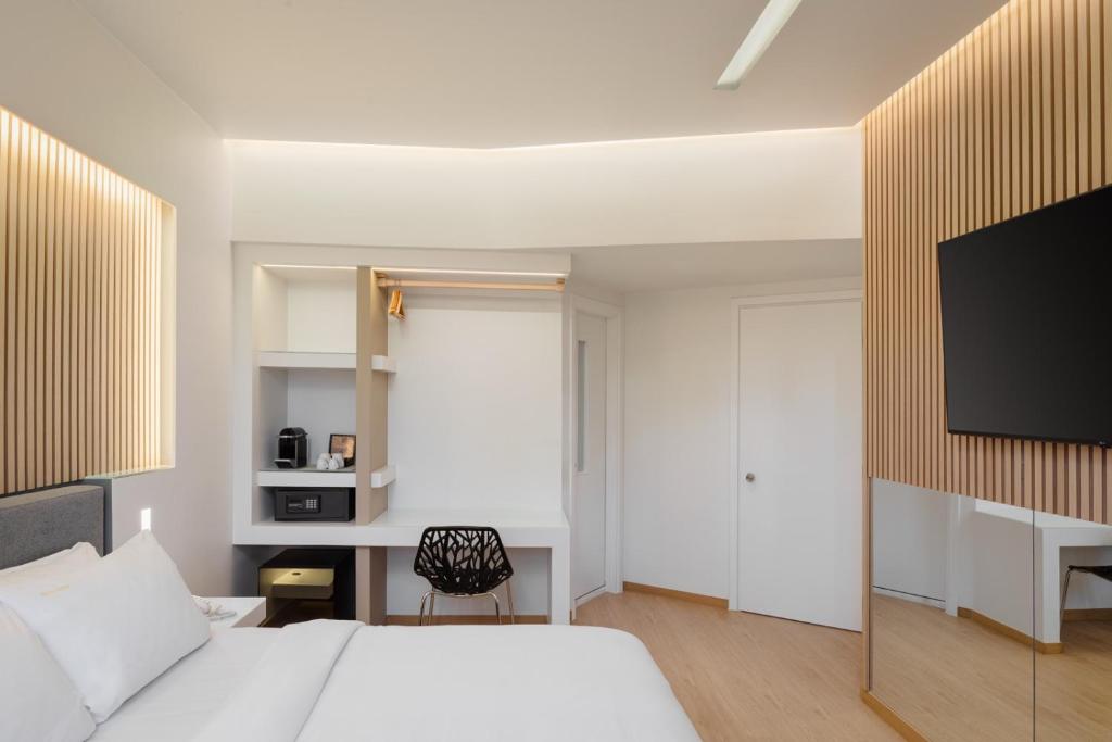Postel nebo postele na pokoji v ubytování Kreoli Hotel