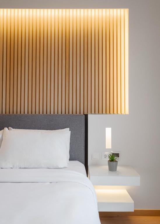 Postel nebo postele na pokoji v ubytování Kreoli Hotel