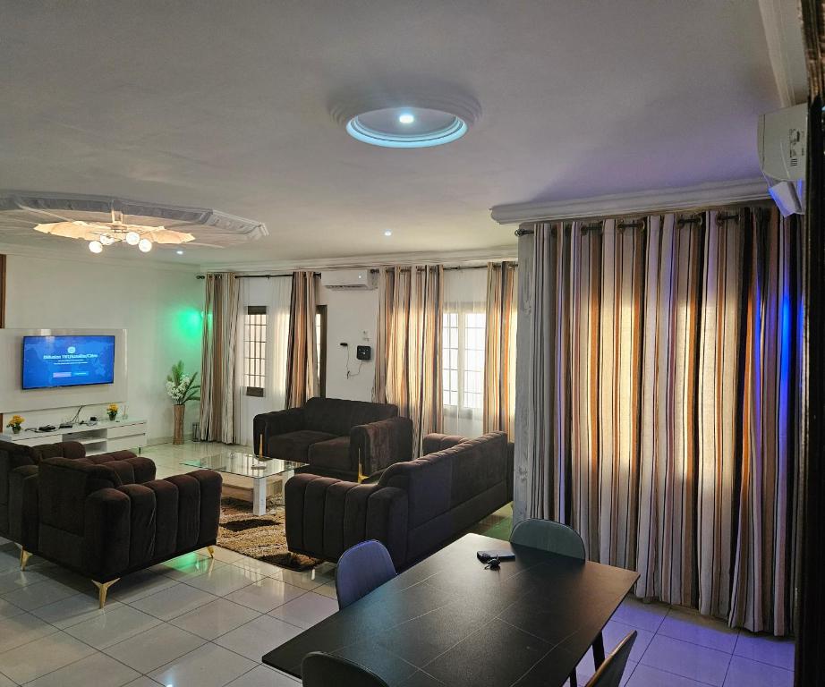 a living room with couches and a table at Villa Blue Serenity in Lomé