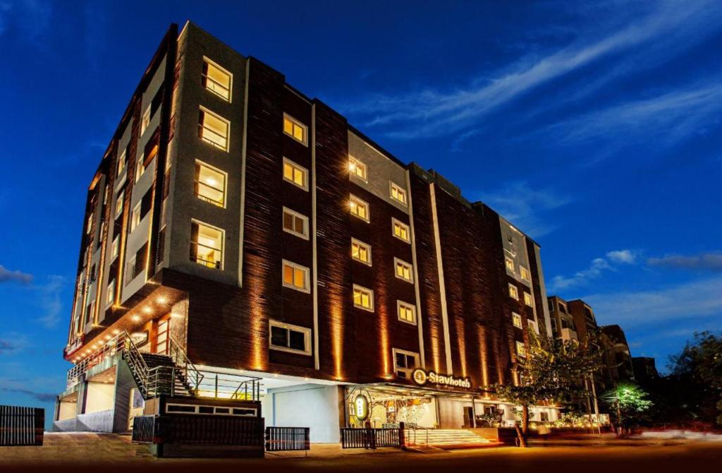 a large building is lit up at night at Hotel I-stay Hitec in Hyderabad
