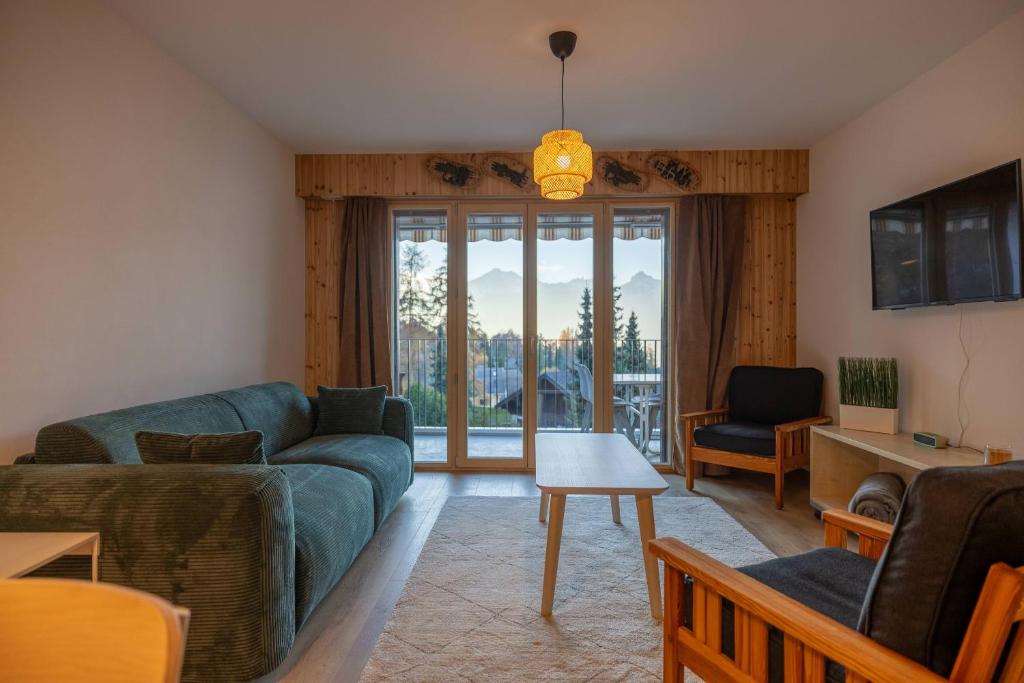 a living room with a couch and a table at Petit Nid au Chaedoz - Nendaz, 4 Vallées in Nendaz