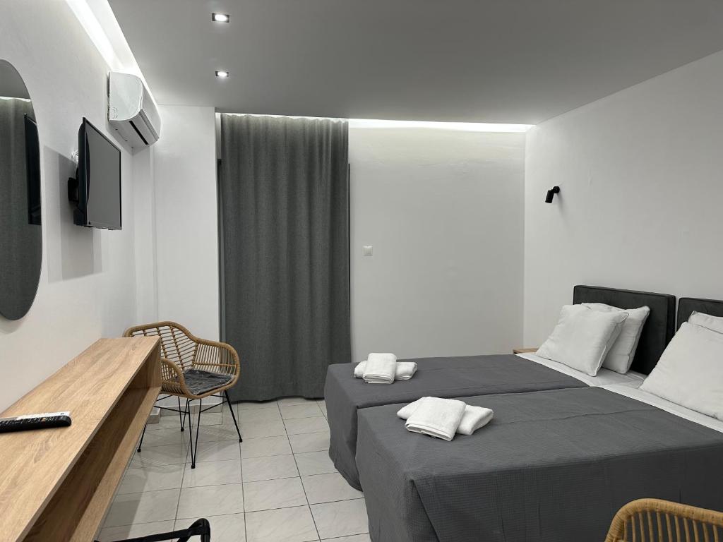 Postel nebo postele na pokoji v ubytování Olympian Altis Hotel
