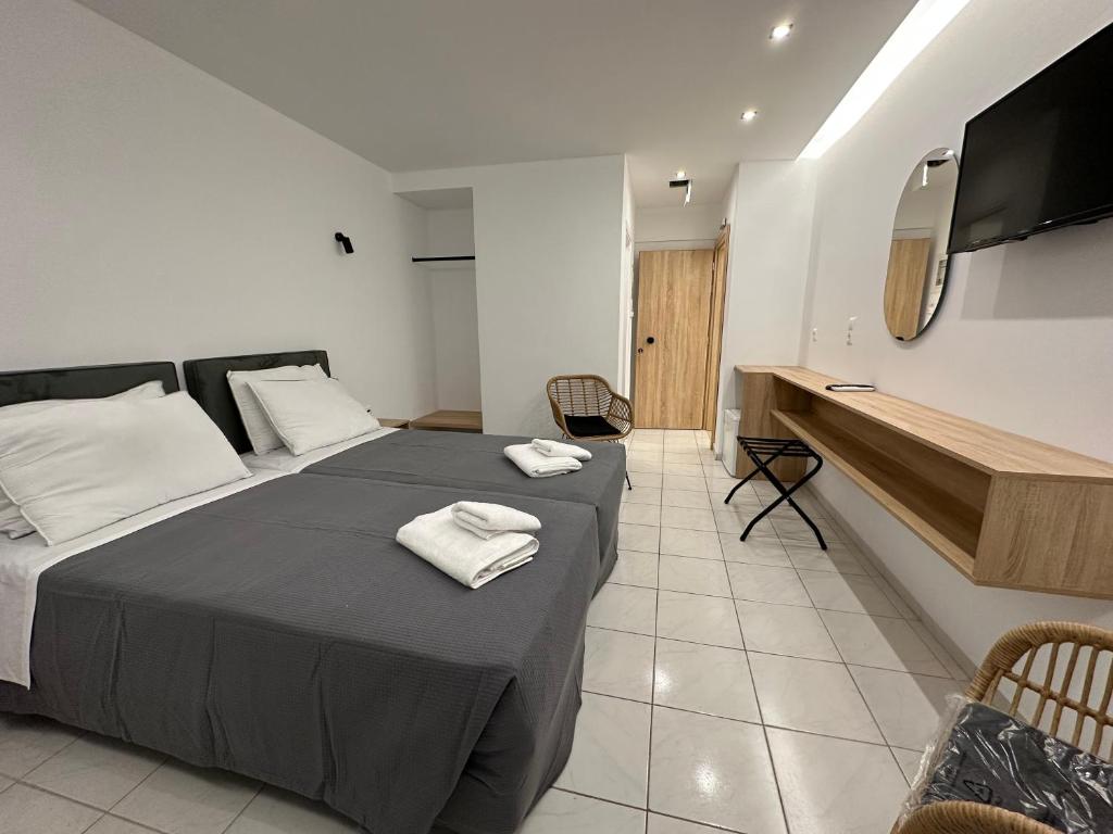 Postel nebo postele na pokoji v ubytování Olympian Altis Hotel