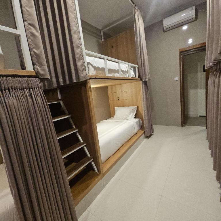 Postel nebo postele na pokoji v ubytování Ungasan Center Hostel