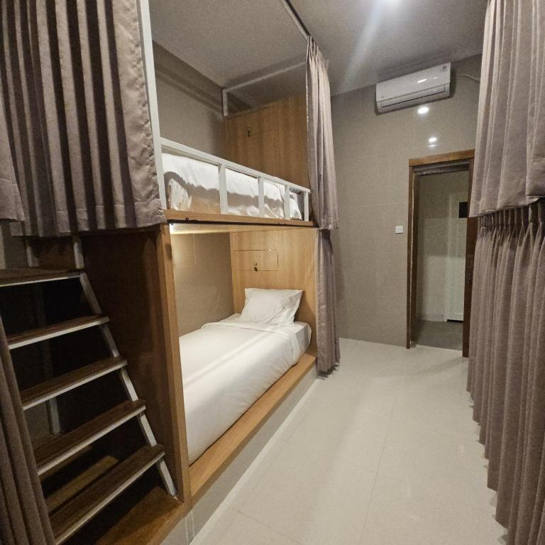 Postel nebo postele na pokoji v ubytování Ungasan Center Hostel