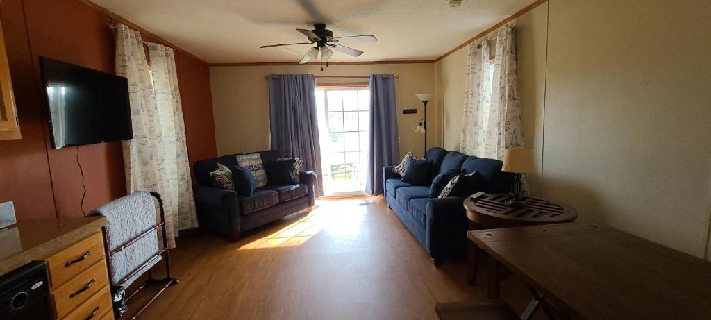 a living room with a blue couch and a window at The Beach House in Hillsboro