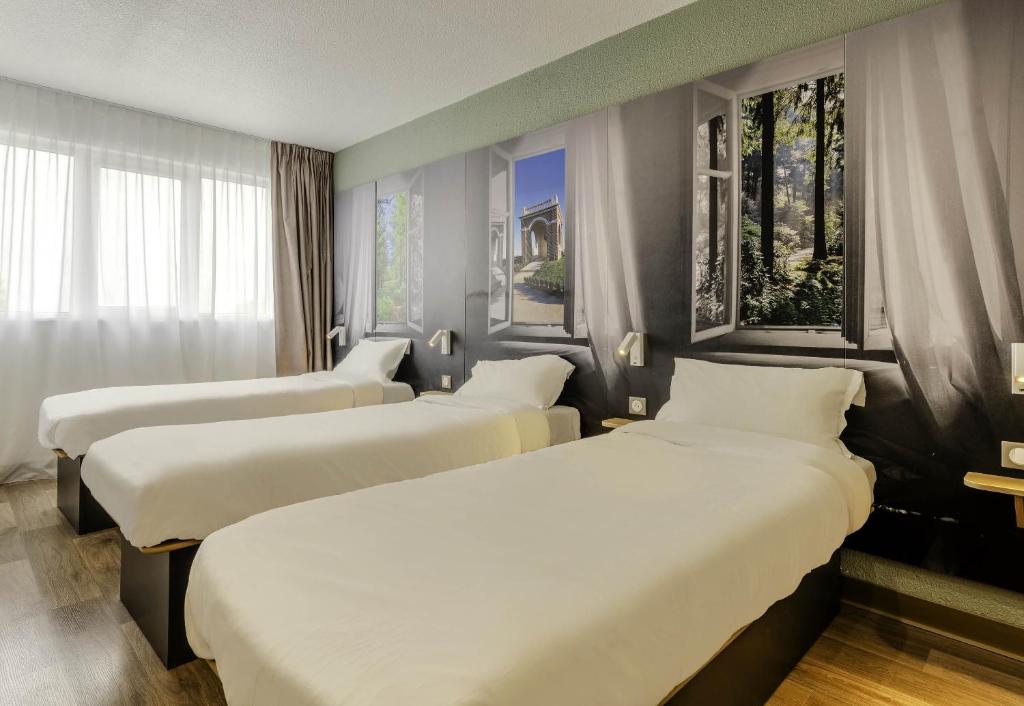Postel nebo postele na pokoji v ubytování B&B HOTEL Cambrai