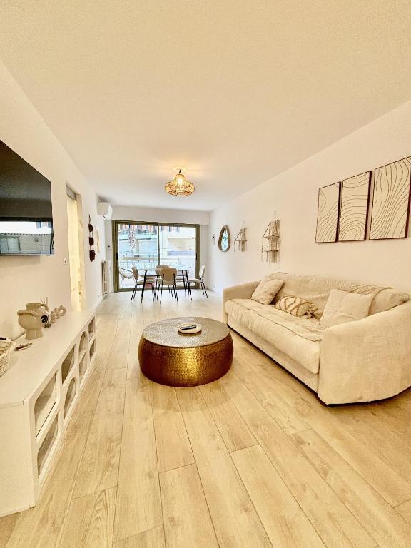 un salon avec un canapé et une table dans l'établissement Résidence Neptunia, à Juan-les-Pins