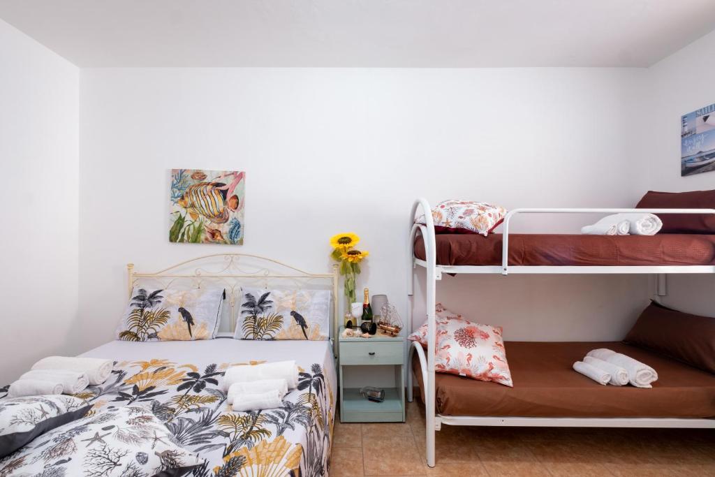a bedroom with a bunk bed and a bunk bed at On The Beach San Foca in San Foca