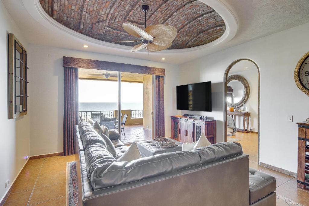 a living room with a leather couch and a ceiling fan at 350 Sq Ft Balcony Oceanfront Puerto Peñasco Villa in Puerto Peñasco