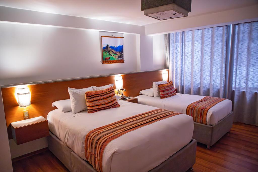 Postel nebo postele na pokoji v ubytování Ausangate Hotel Machupicchu