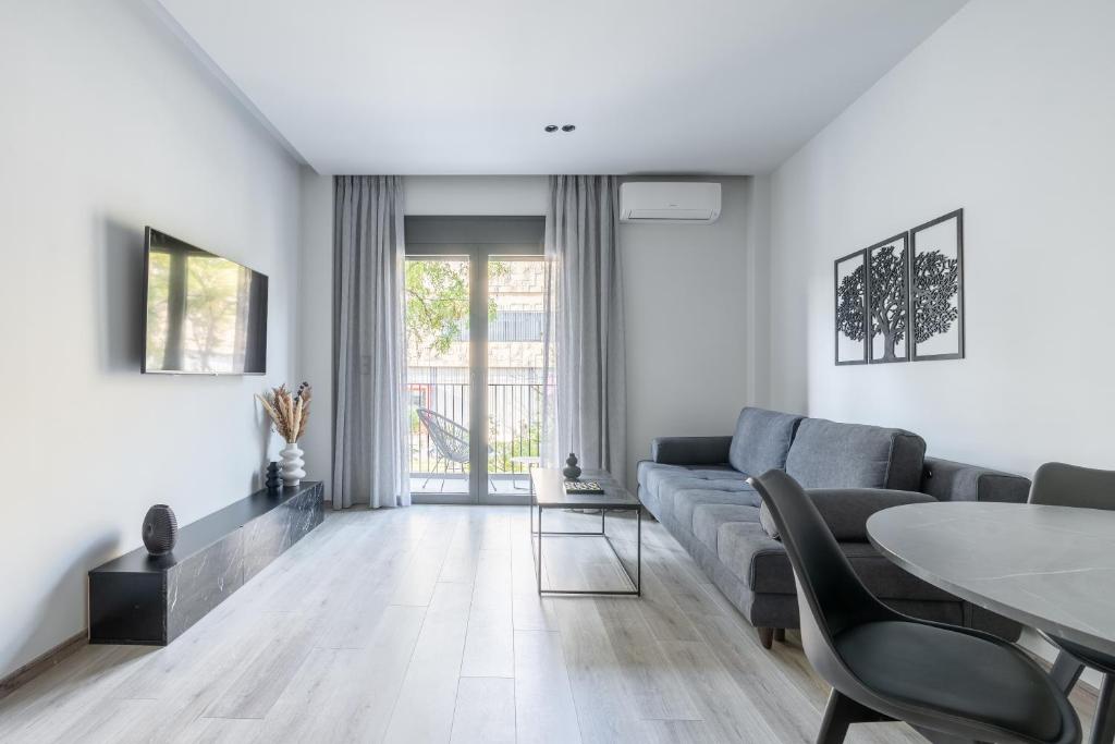 a living room with a couch and a table at EN Suites Stylish & Comfort Stay near Acropolis in Athens