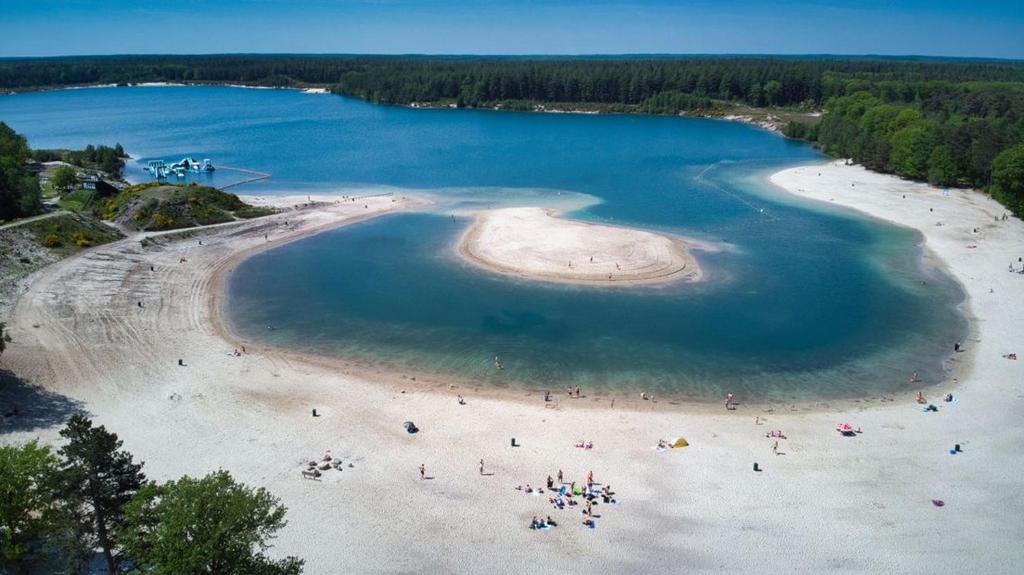 an aerial view of a beach with people in the water at Vakantiehuisje drenthe gasselterveld in Gasselte