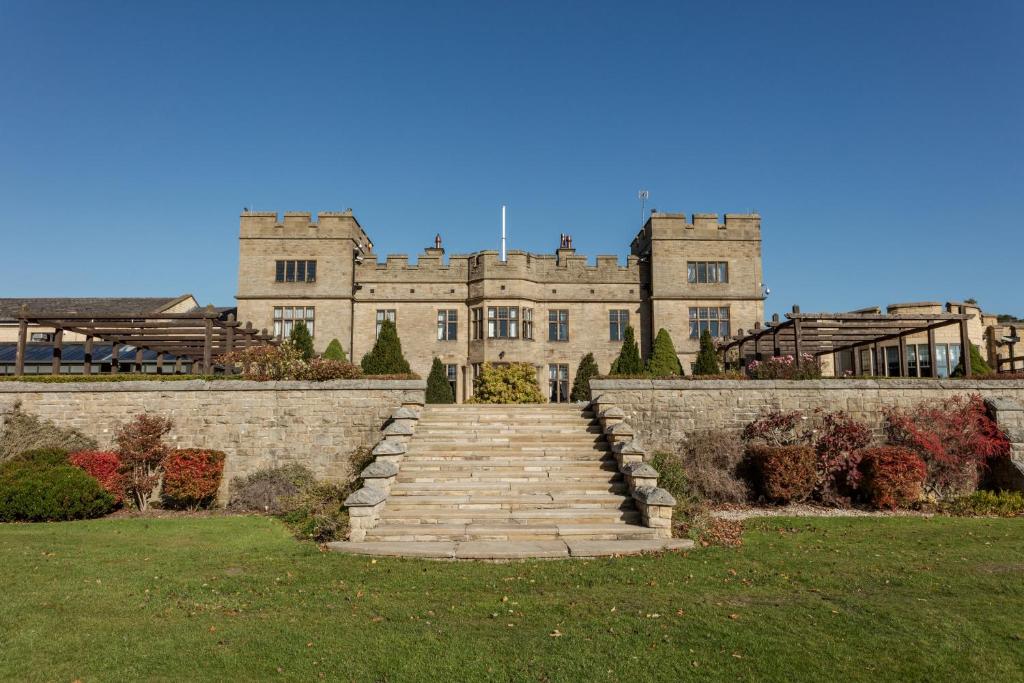 a large castle with a staircase in front of it at Slaley Hall Hotel, Spa & Golf Resort in Slaley