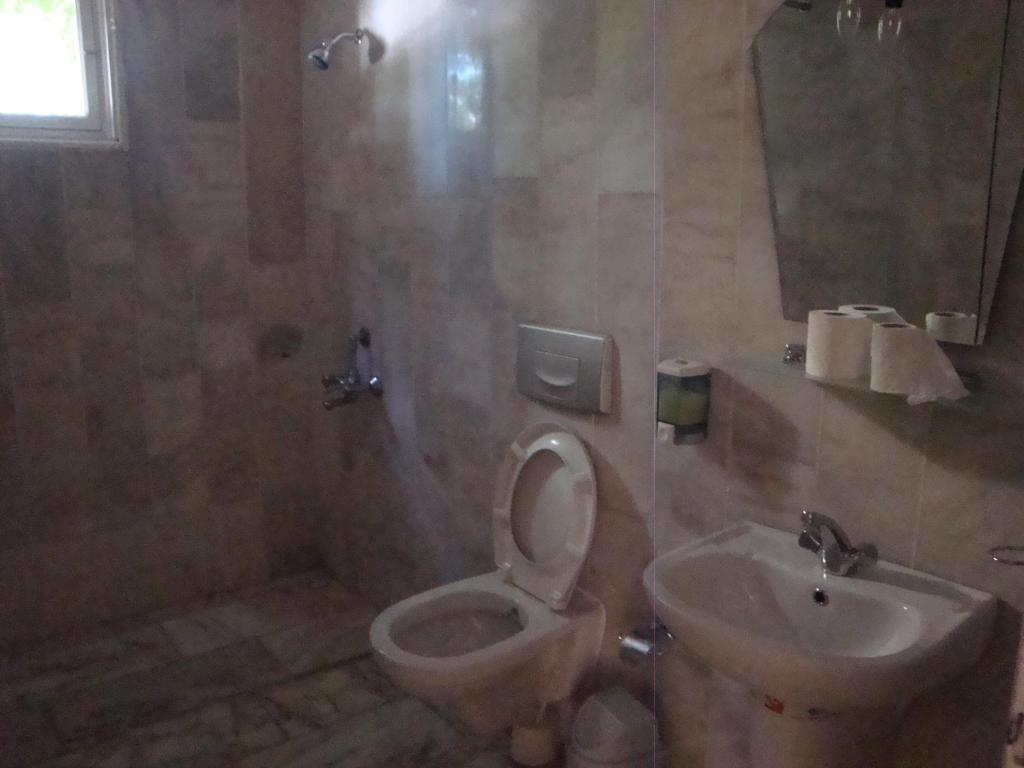 a bathroom with a toilet and a sink at Hotel Anadolu in Finike