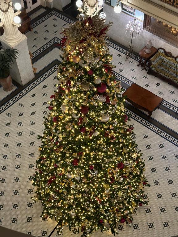 a christmas tree on the floor of a room at Menger Hotel in San Antonio