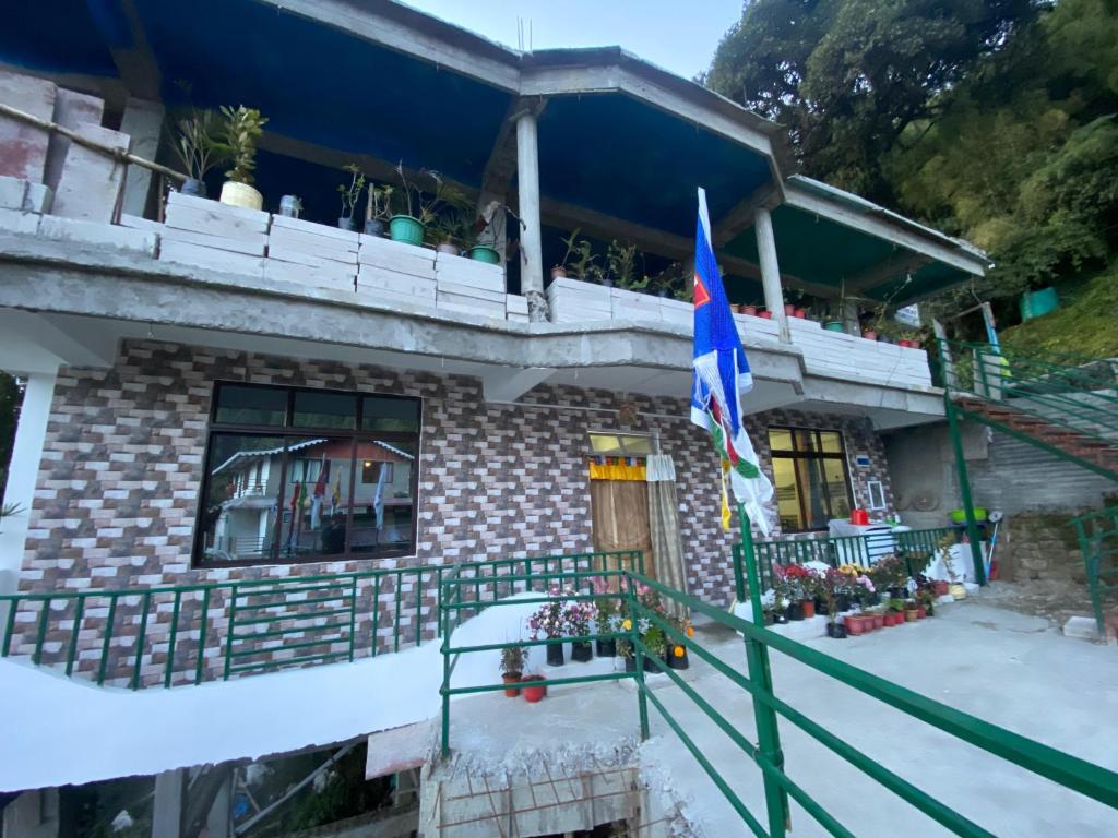 a house with a flag in front of it at Samendo-Retreat Homestay in Sukhia Pokhari