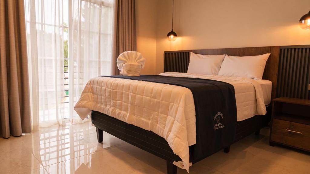 Postel nebo postele na pokoji v ubytování Hotel Boutique Nueva Valladolid