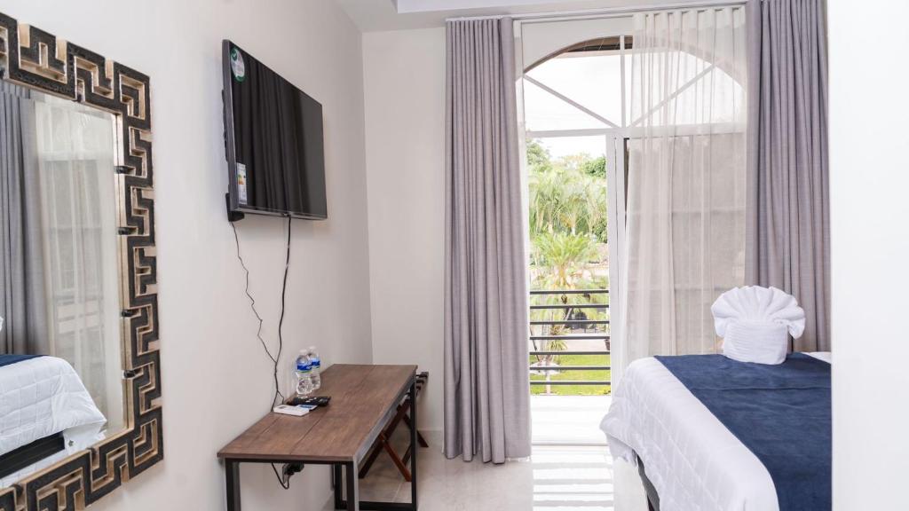 Postel nebo postele na pokoji v ubytování Hotel Boutique Nueva Valladolid
