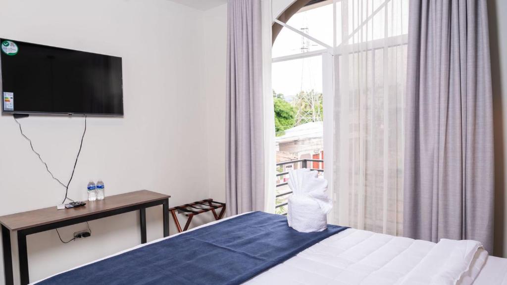 Postel nebo postele na pokoji v ubytování Hotel Boutique Nueva Valladolid