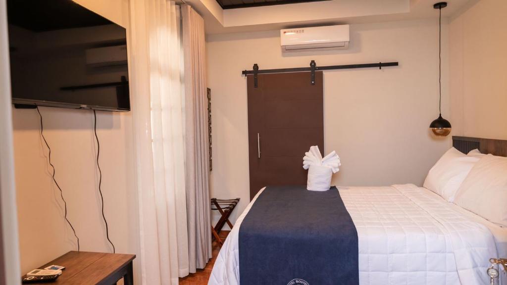 Postel nebo postele na pokoji v ubytování Hotel Boutique Nueva Valladolid