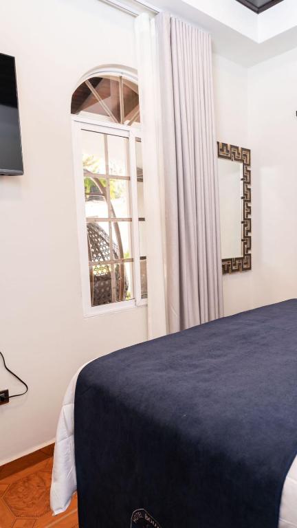 Postel nebo postele na pokoji v ubytování Hotel Boutique Nueva Valladolid