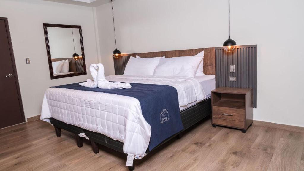 Postel nebo postele na pokoji v ubytování Hotel Boutique Nueva Valladolid