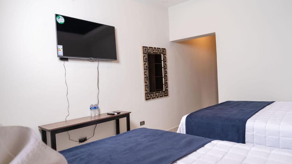 Postel nebo postele na pokoji v ubytování Hotel Boutique Nueva Valladolid