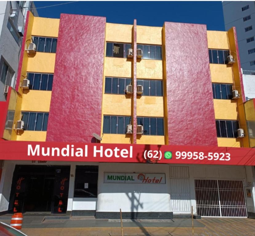 a hotel with a red and yellow building at Mundial Hotel in Goiânia