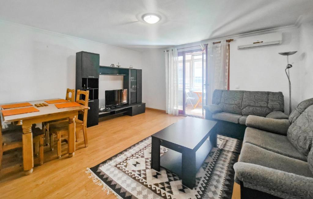 a living room with a couch and a table at Cozy Apartment In Torrevieja With Wifi in Torrevieja