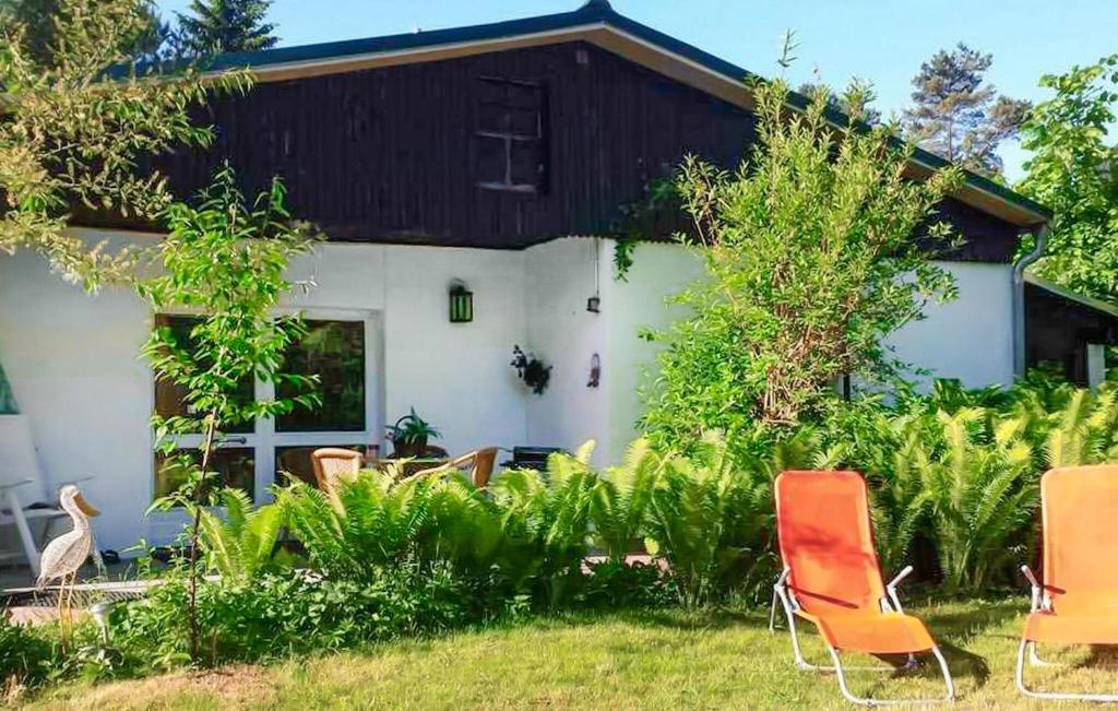 a house with orange chairs in front of it at Ferienhaus Mahlow in Mahlow