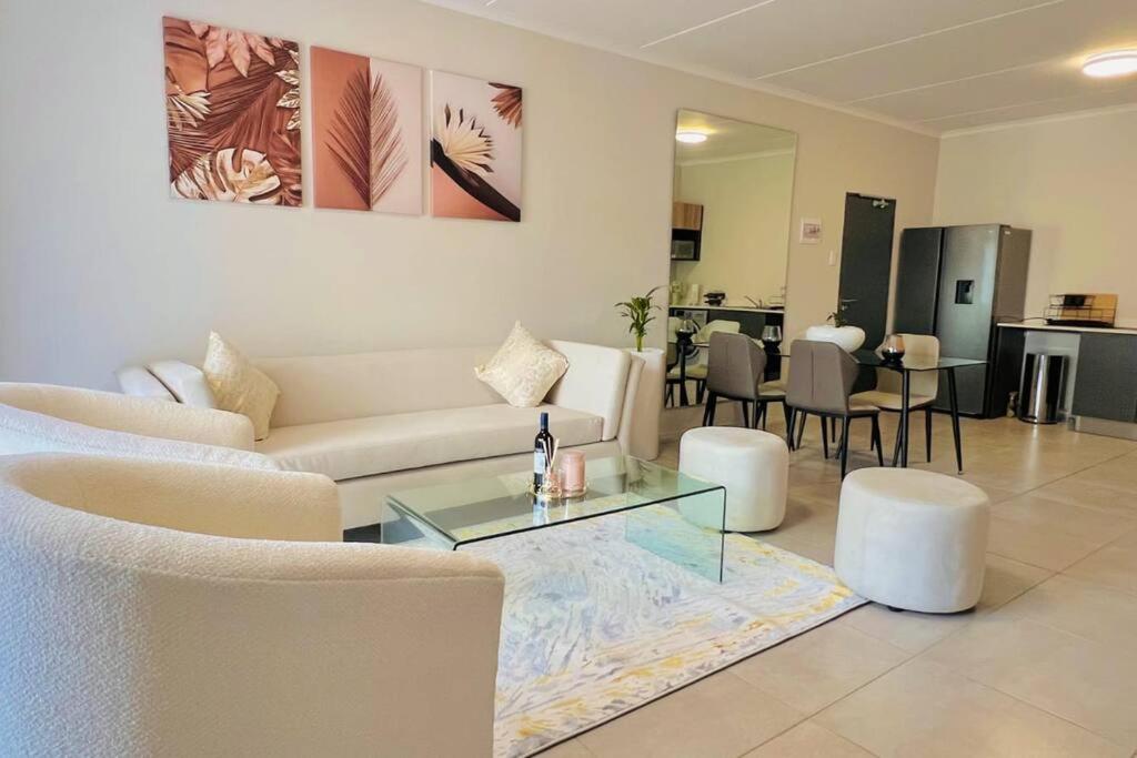 a living room with a couch and a table at Sunset Haven in Midrand