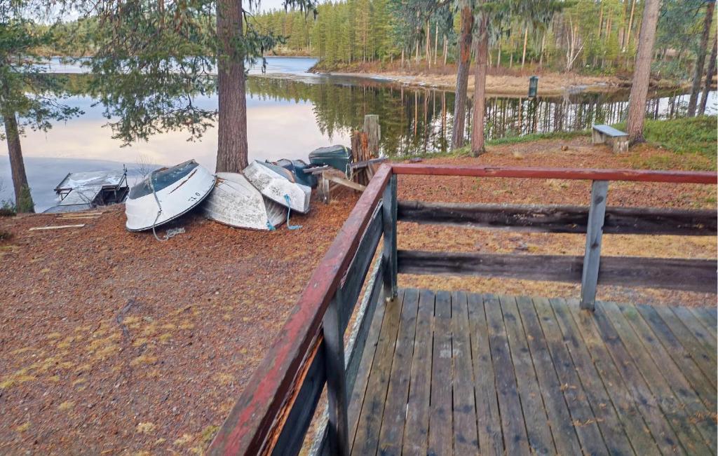 two boats are parked on the shore of a lake at Gorgeous Home In Särna With Sauna in Ringbo