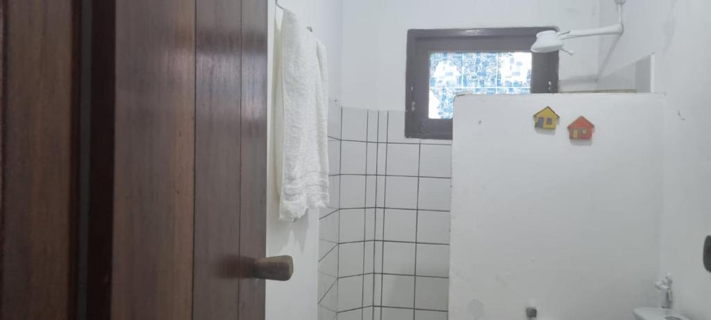 a white refrigerator in a kitchen with a window at Casa Recanto in Trancoso