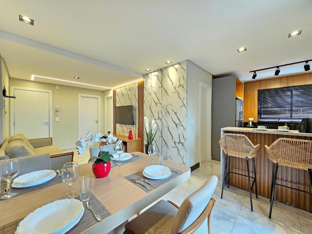 une salle à manger et une cuisine avec une table et des chaises dans l'établissement Centro 2 quartos 2 banheiros - alto padrao novo, à Foz do Iguaçu