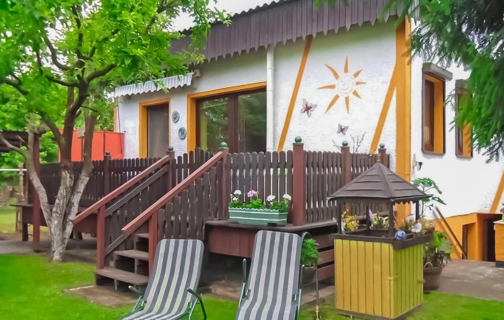 a house with a table and chairs in front of it at Ferienhaus Waren Müritz in Waren