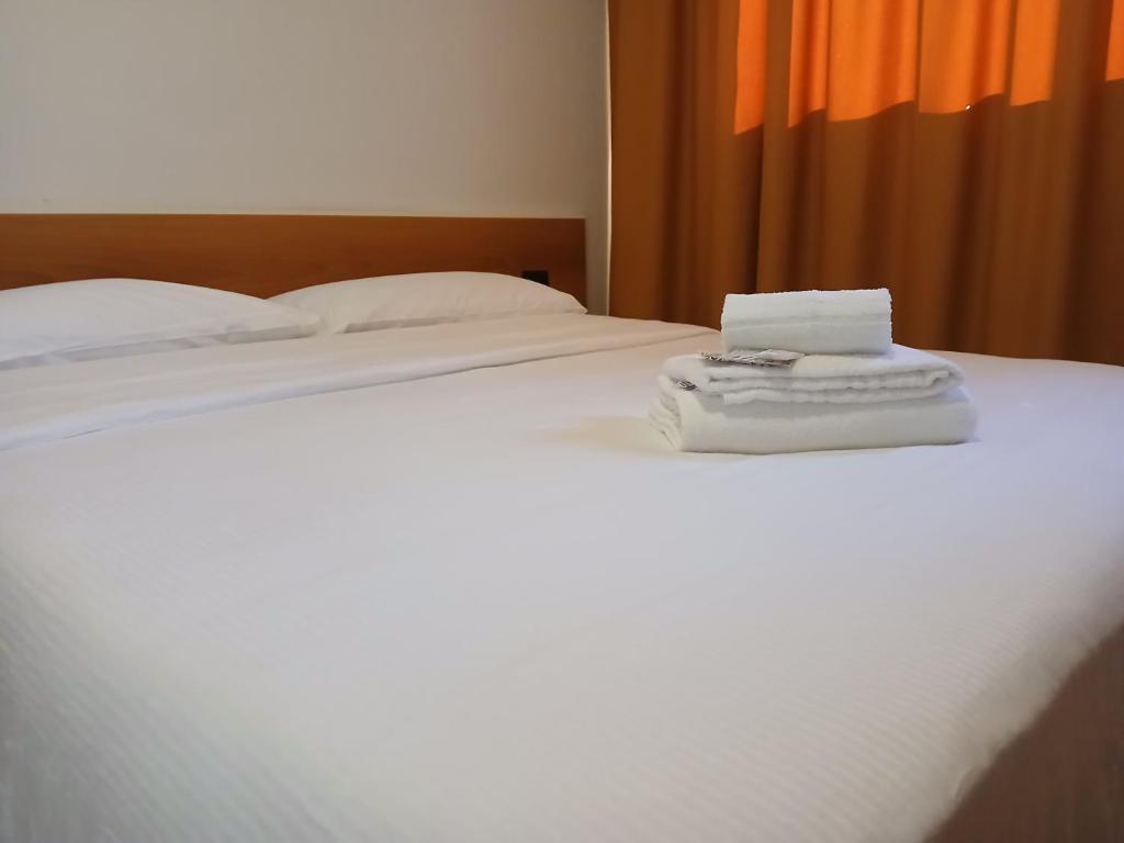 Postel nebo postele na pokoji v ubytování Hotel Ponsacco HP