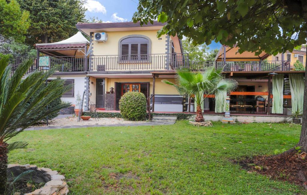 a large house with a balcony and a yard at Amazing Home In Trecastagni With Sauna in Trecastagni