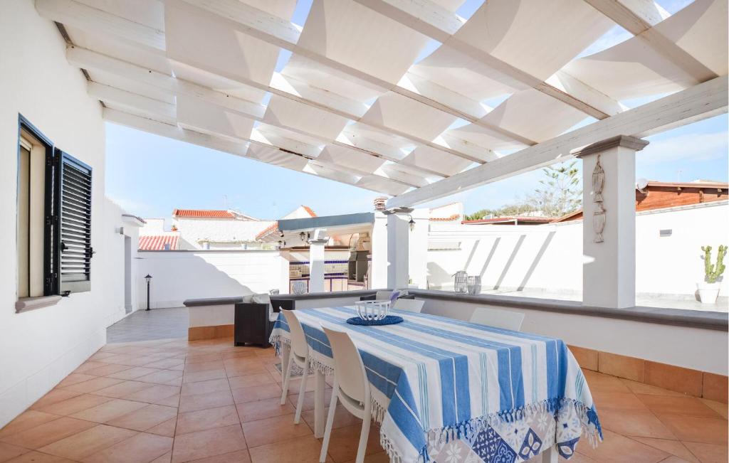 a dining room with a table and chairs at 2 Bedroom Amazing Home In Triscina in Triscina