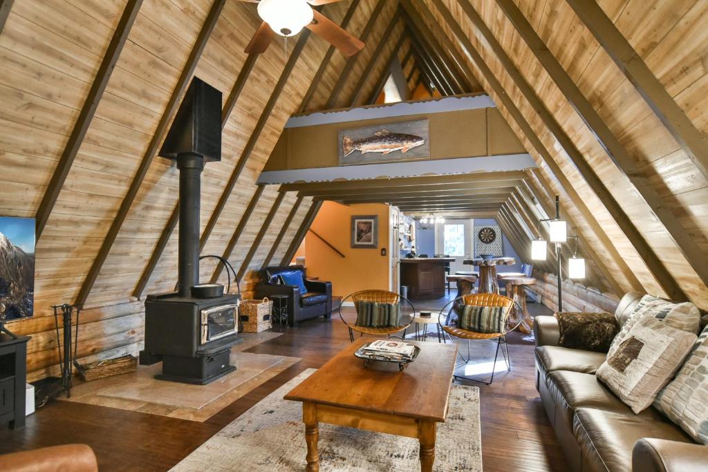 a living room with a fireplace in a house at Spruce Creek Lodge: Classic A-Frame Mountain Retreat in Blue River