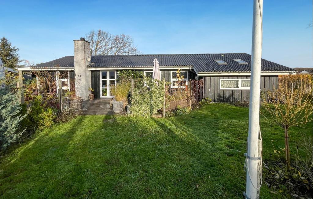 a house with a yard in front of it at 3 Bedroom Cozy Home In Nibe in Nibe