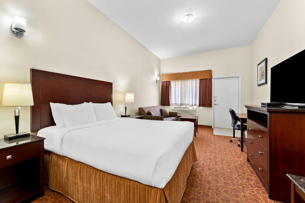 a hotel room with a large bed and a desk at Best Western Williams Lake in Williams Lake