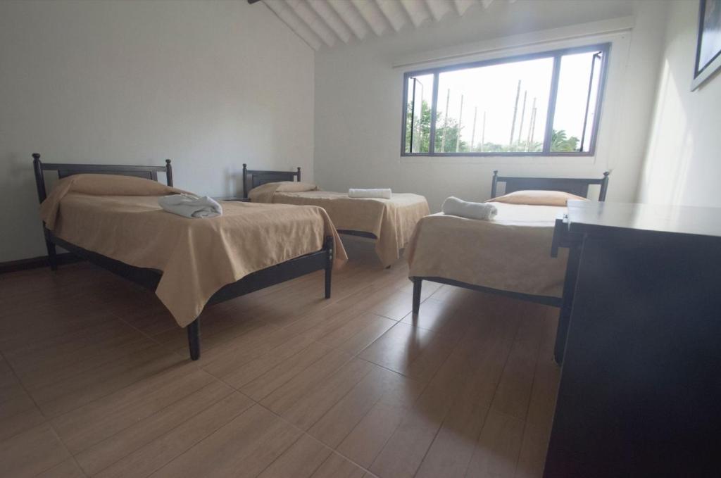 Postel nebo postele na pokoji v ubytování Tacuara Hotel
