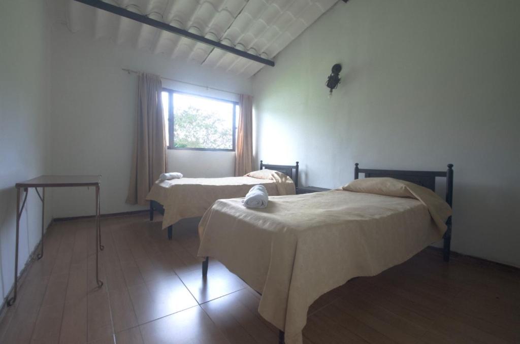 Postel nebo postele na pokoji v ubytování Tacuara Hotel