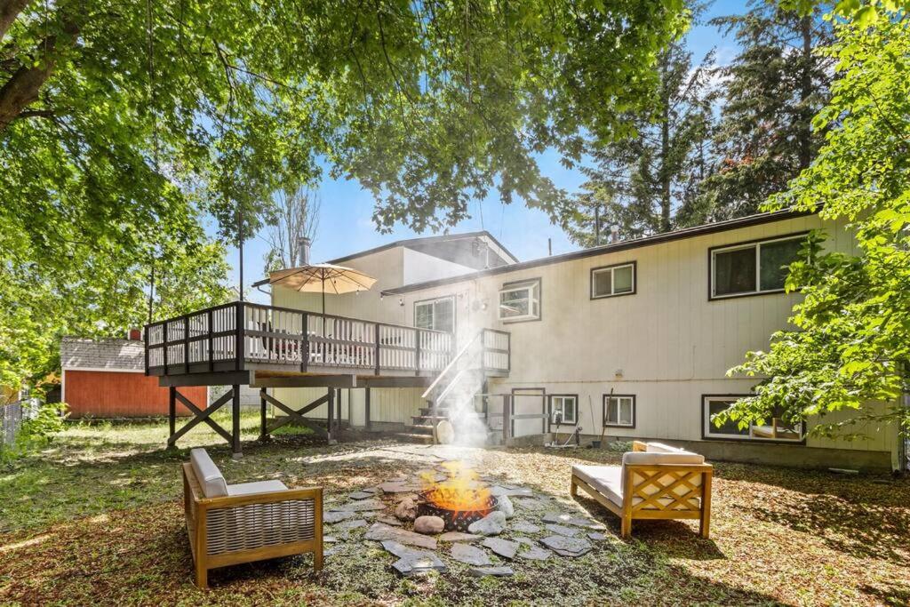 a house with a fire pit in the yard at Hot Tub and Spacious Backyard Close to Lake! in Coeur d'Alene