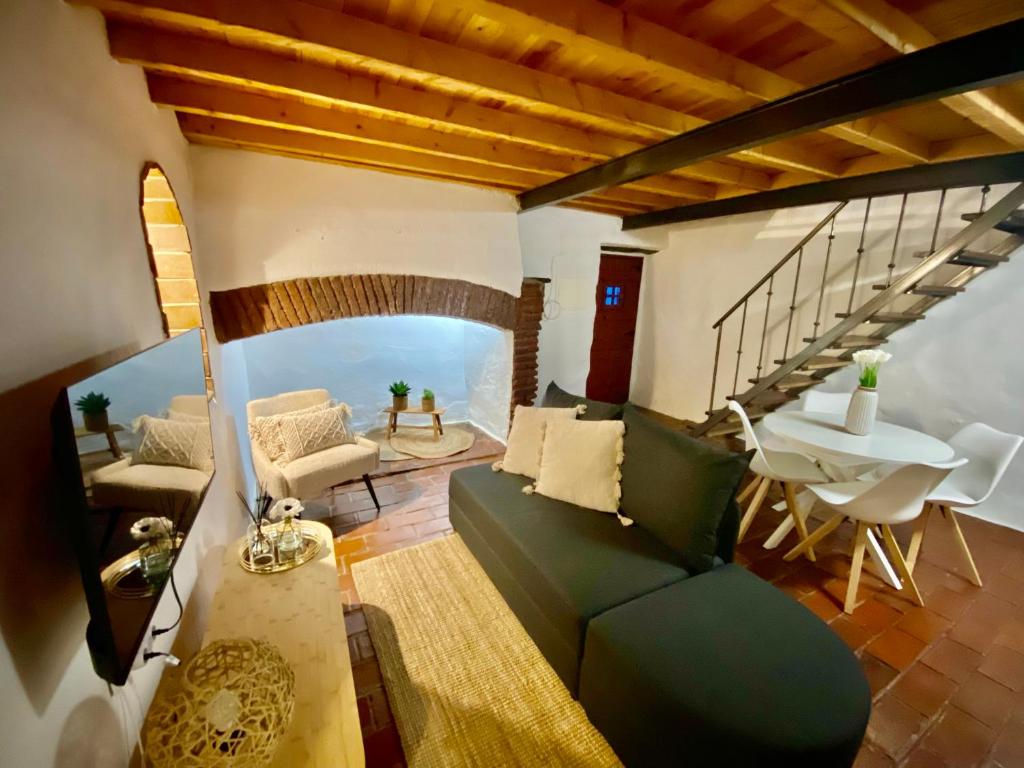 a living room with a green couch and a table at Casa do Montado in Portel