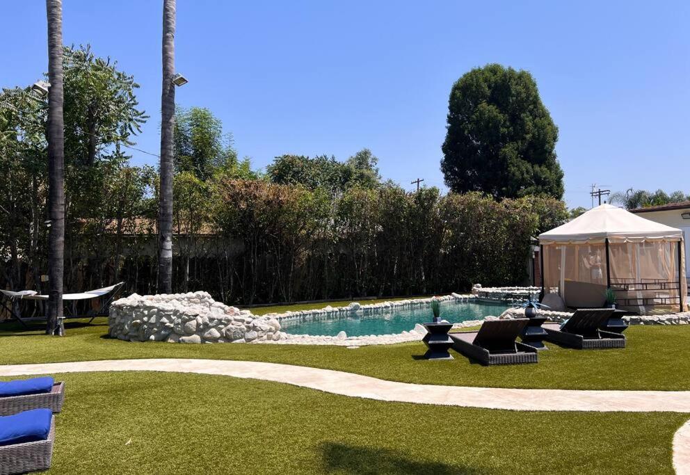a backyard with a swimming pool and a gazebo at Luxury Oasis in Central Encino w Pool & Spa Topeka in Los Angeles