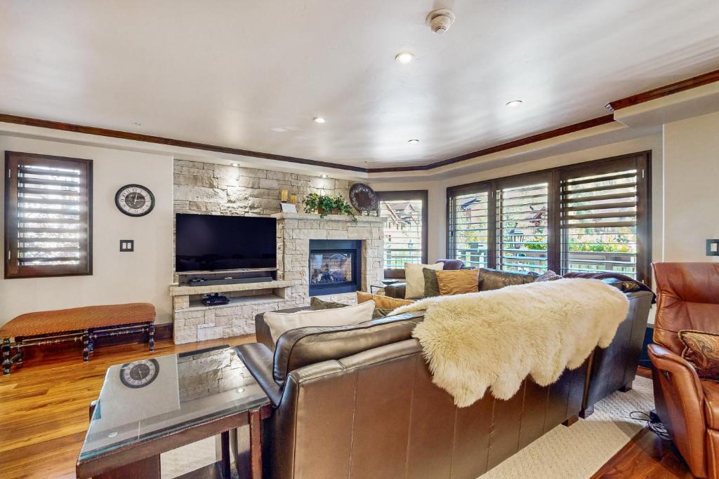 a living room with a couch and a fireplace at Lion Square Lodge North 280 in Vail
