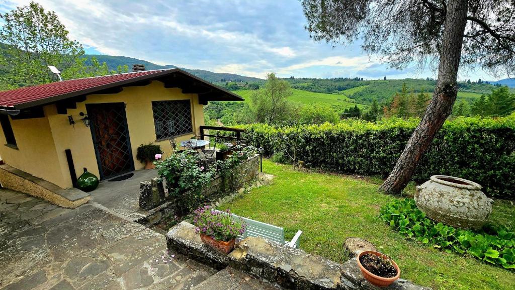 a small house with a yard with flowers and plants at Amore in Chianti in Greve in Chianti