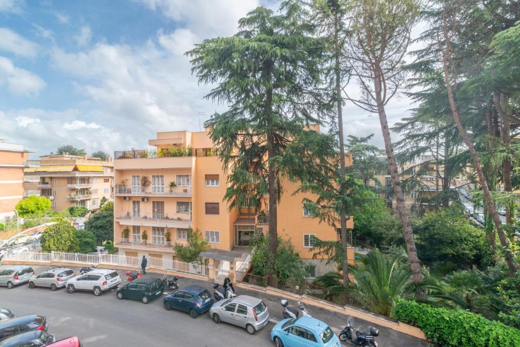 un parcheggio con auto parcheggiate di fronte a un edificio di Casa Eva - Roma a Roma